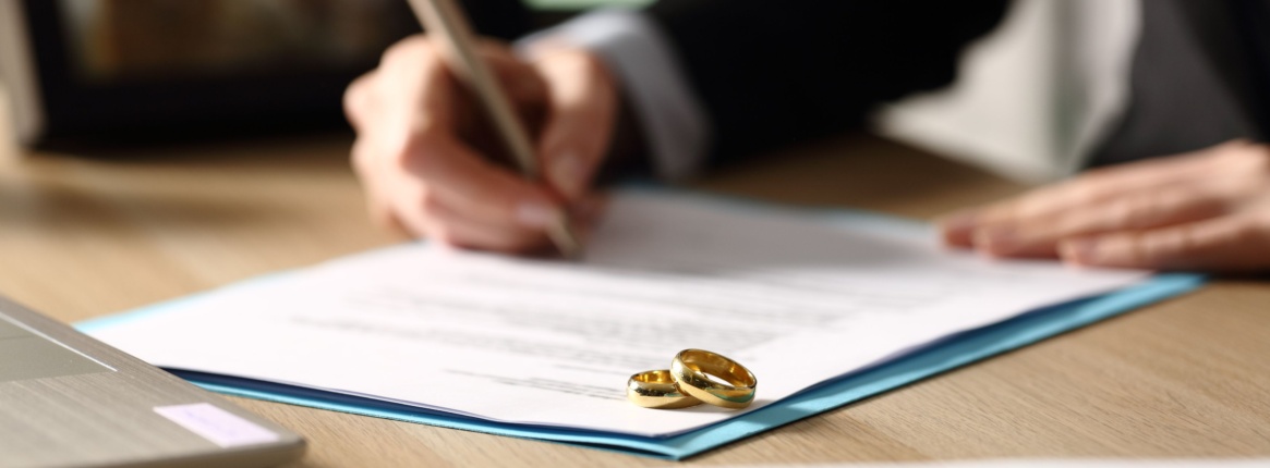 A Person Signing Their Divorce Papers